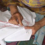 A woman practices her embroidery skills A woman practices her embroidery skills