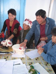 Handicraft production Kyrgyzstan 2 community members sorting handmade slippers
